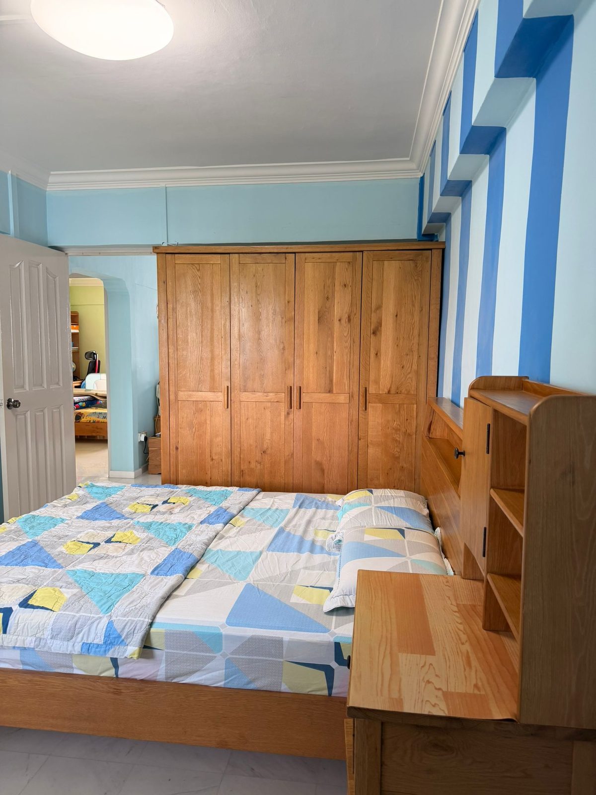Wooden wardrobe and bed inside the master bedroom