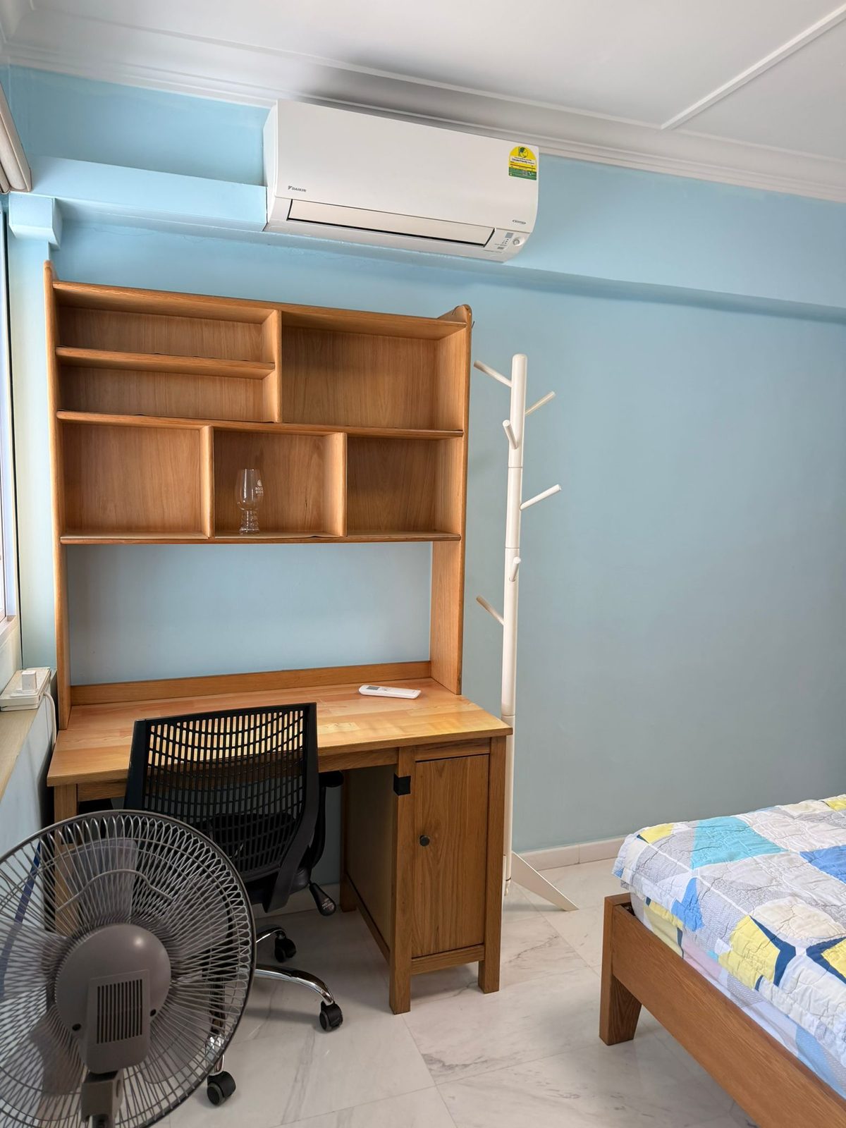 Study desk, chair, shelving, fan, and air-conditioner in the bedroom